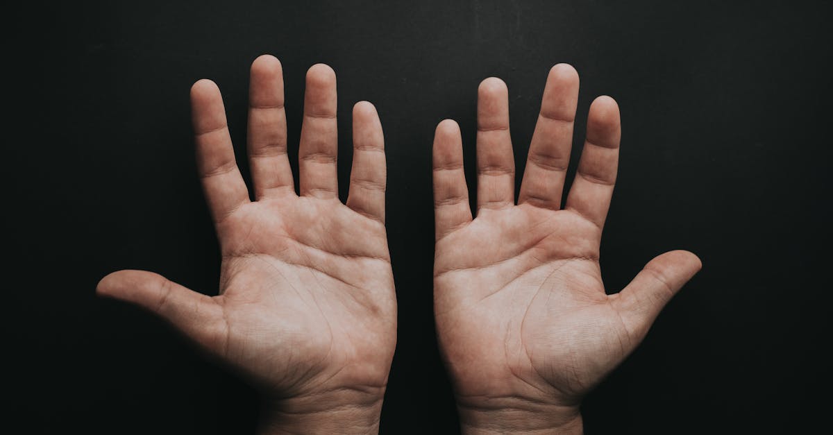 A close-up image of two open palms on a dark background, conveying a sense of openness.